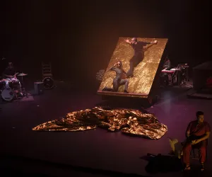 Two dancers present their show standing on a platform.